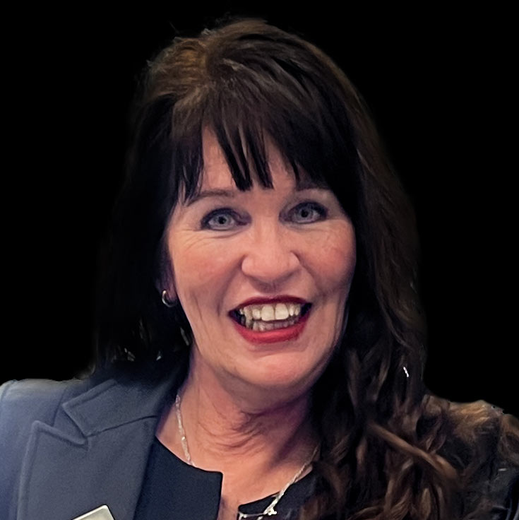A headshot of Natalie against a black background
