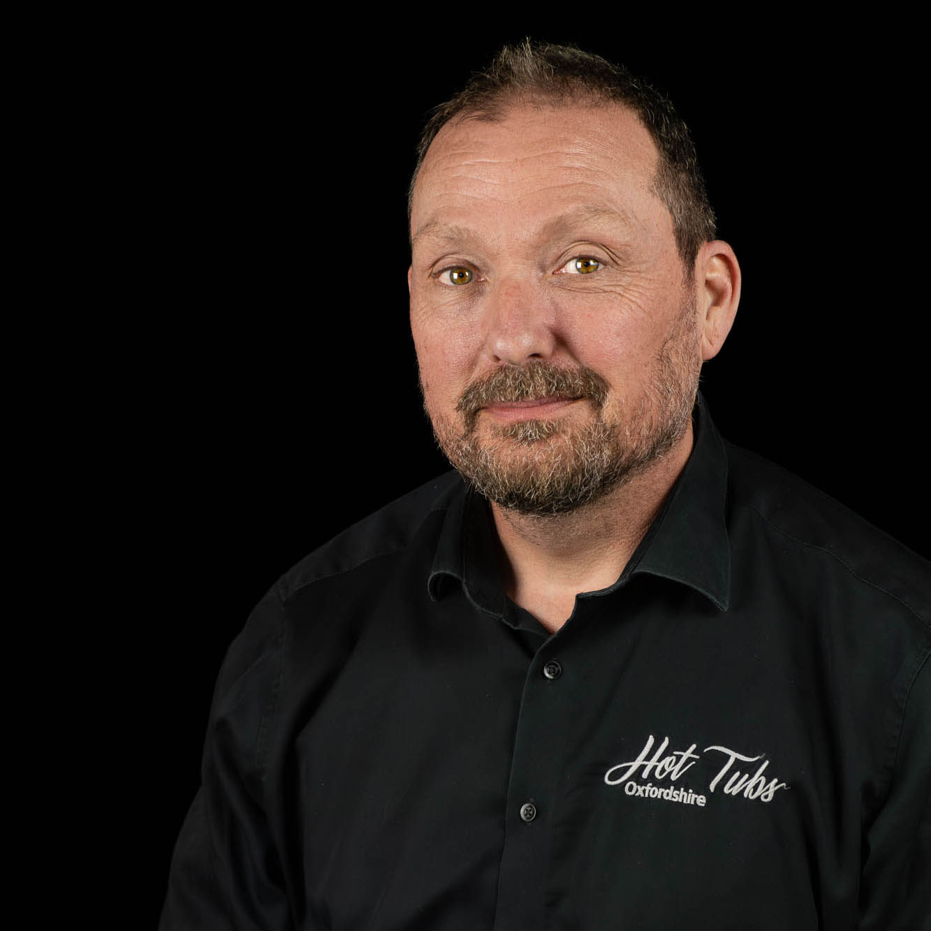 A headshot of Chris Hands against a black background