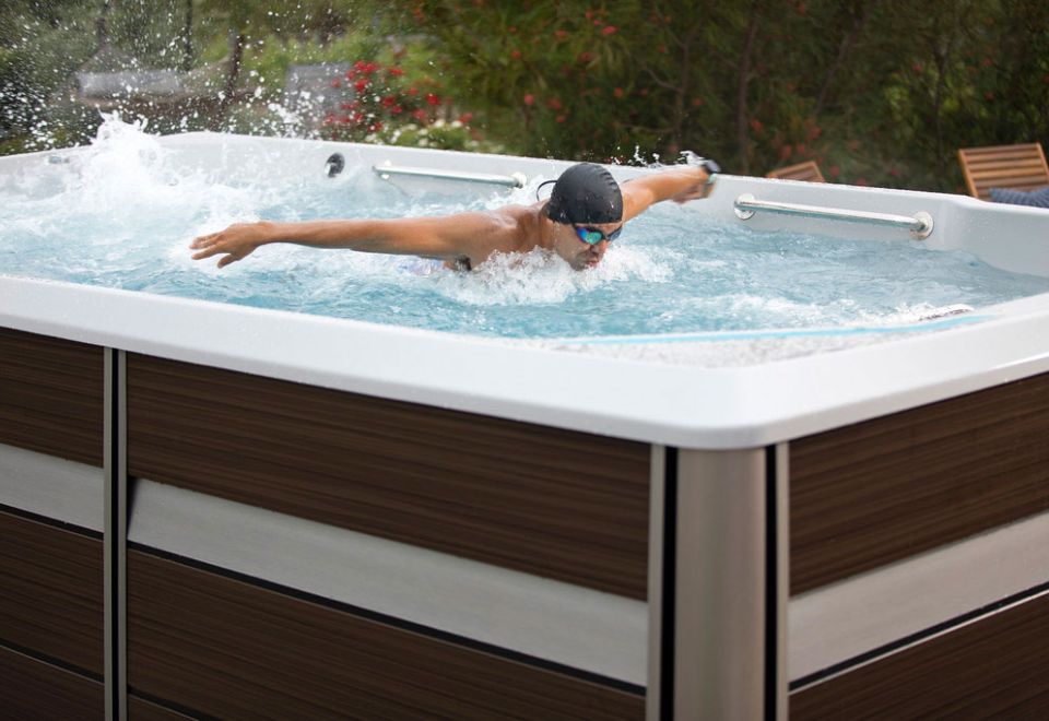 man swimming in swim spa